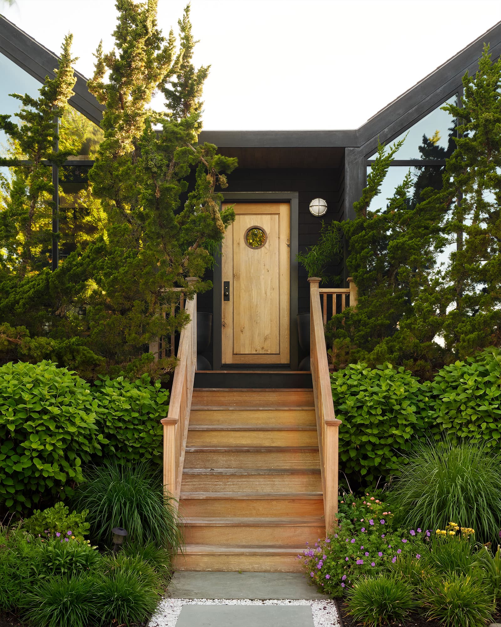 Pine-tar-black door against the harbor light.