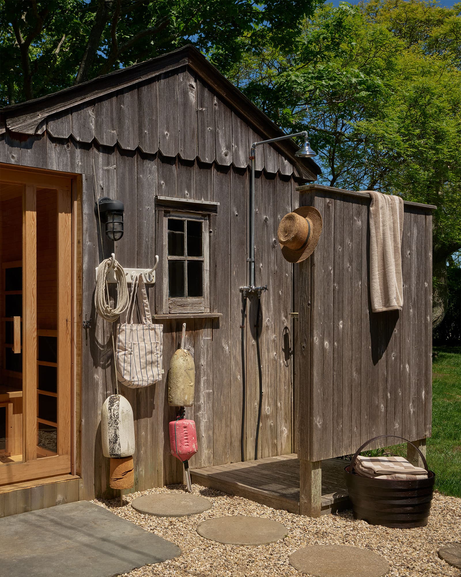 Outdoor shower among the landscaping.